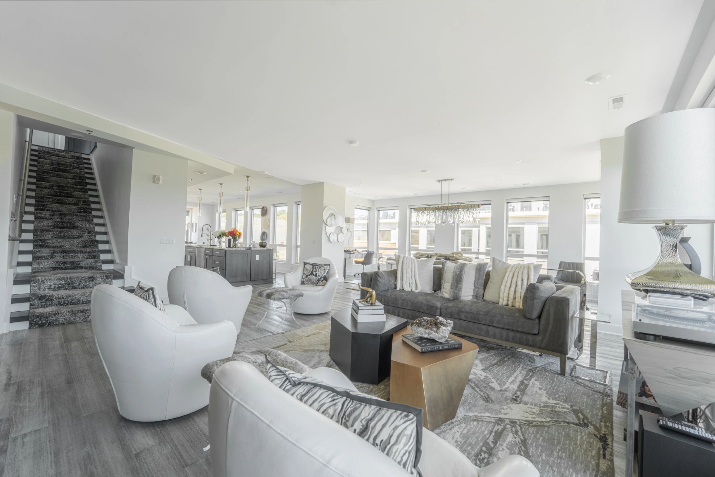 Living room designed by Daniel Home, with layered neutral seating and a sculptural table lamp