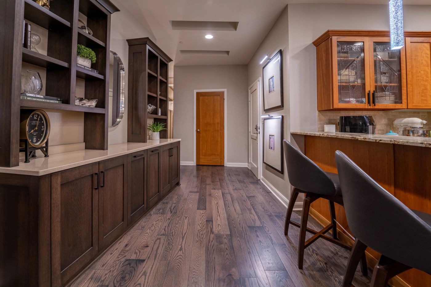 Downtown residence by Daniel Home with dark stained cabinetry and layered lighting