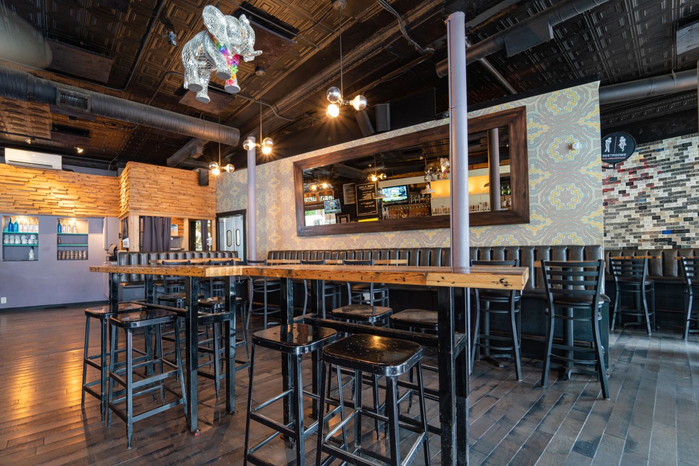 Hospitality interior designed by Daniel Home with banquette seating and warm lighting